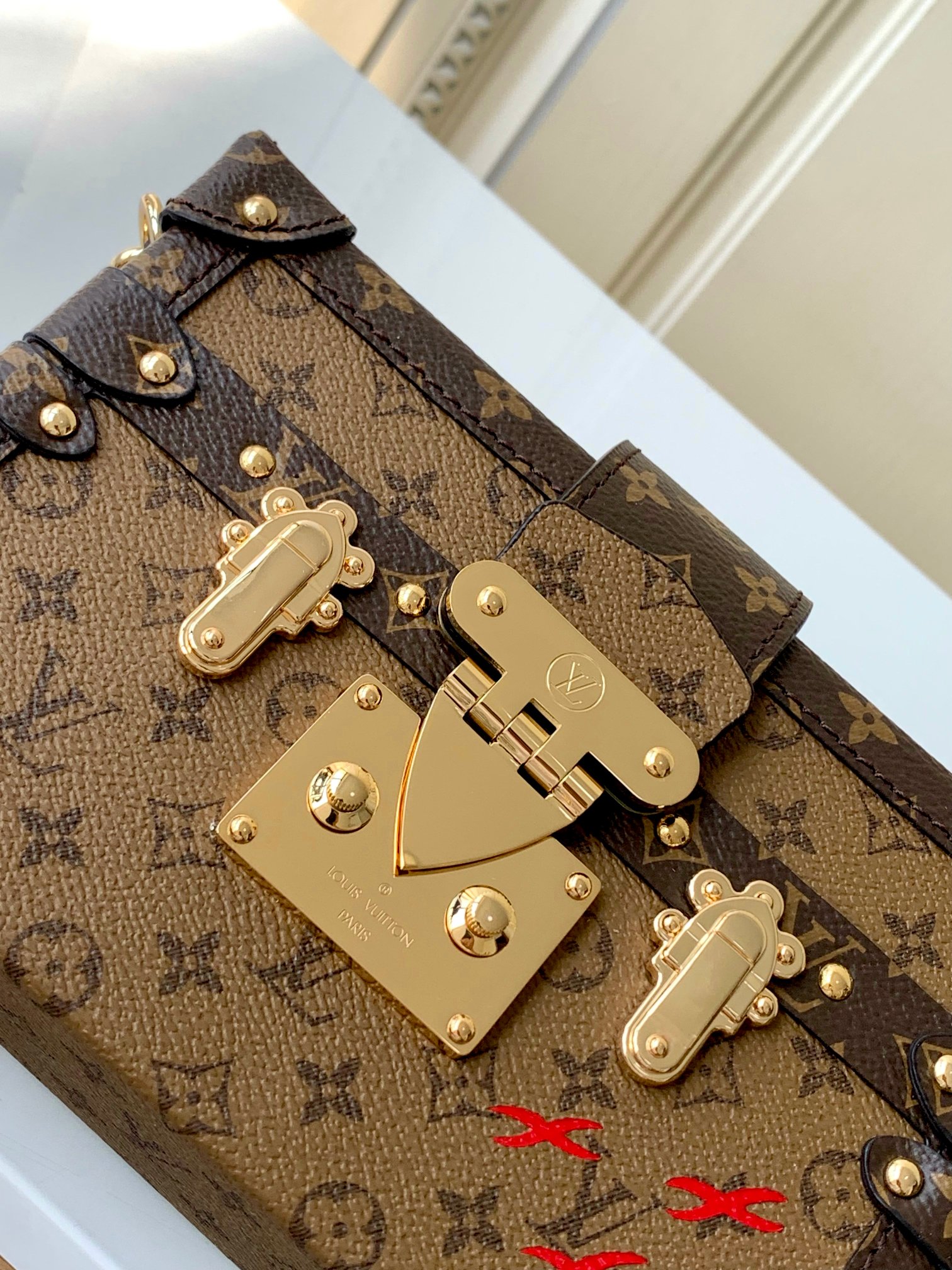 LV PETITE MALLE EAST WEST